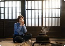 woman sipping tea in Gassho home