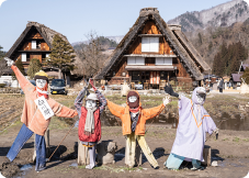 scarecrows in front of Gassho home on a farm